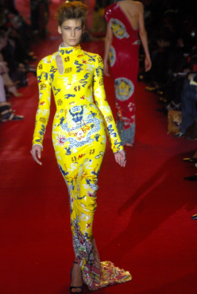 Yves Saint Laurent, Fall 2004: “ "Yves did a 'Chinese' collection in 1977 that was really the point of departure for me when I began designing my 'Chinese' collection. The yellow sequin evening dress that is in the exhibit was in fact inspired by one of the last emperor Puyi's robes." —Tom Ford. Photo Credit: http://www.style.com/