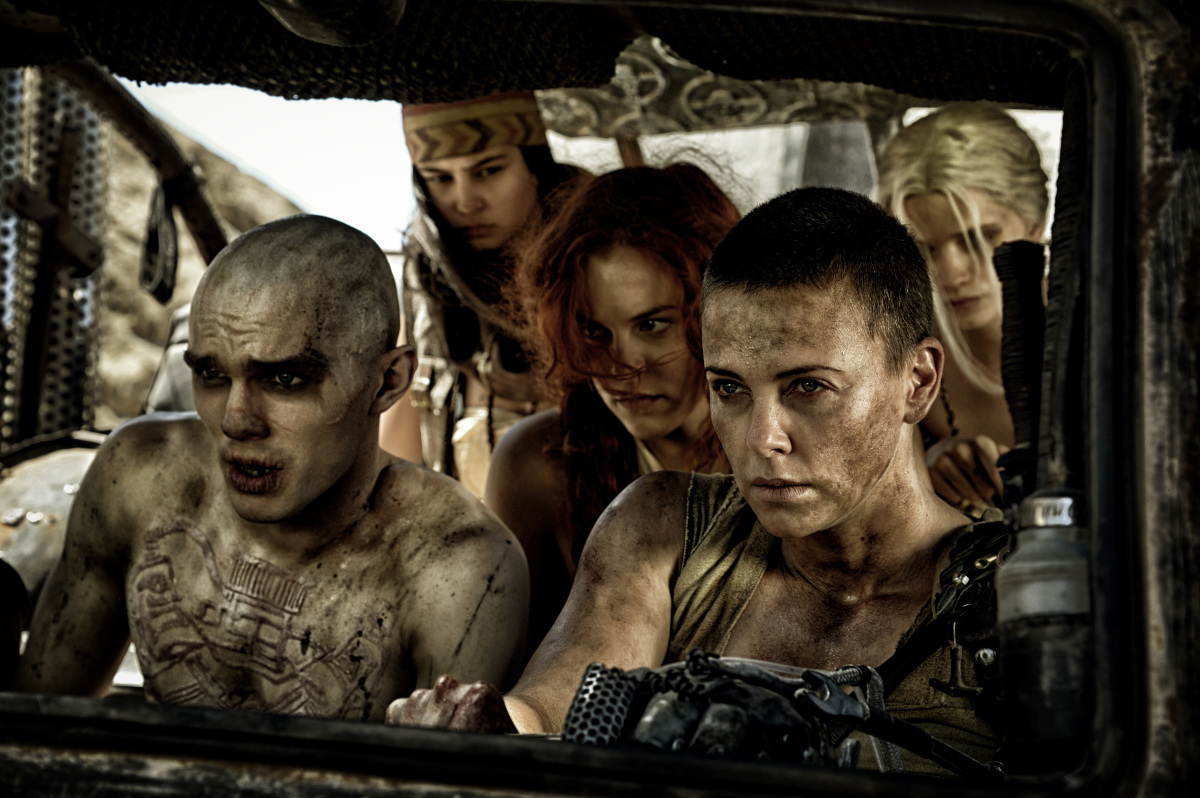 Max isn't the only hero. There's Imperator Furiosa (Charlize Theron) pictured here with female comrades and Nux (Nicholas Hoult). Photo Credit: Warner Bros.