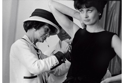 Coco Chanel fitting one of her designs. Image Credit: Douglas Kirkland
