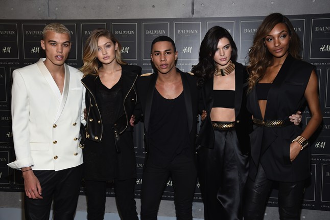 Olivier Rousteing, centre, with models wearing Balmain x H&M, Photo Credit: Getty